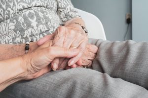 Two older adults holding hands