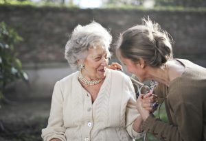 A caregiver talking with an older person