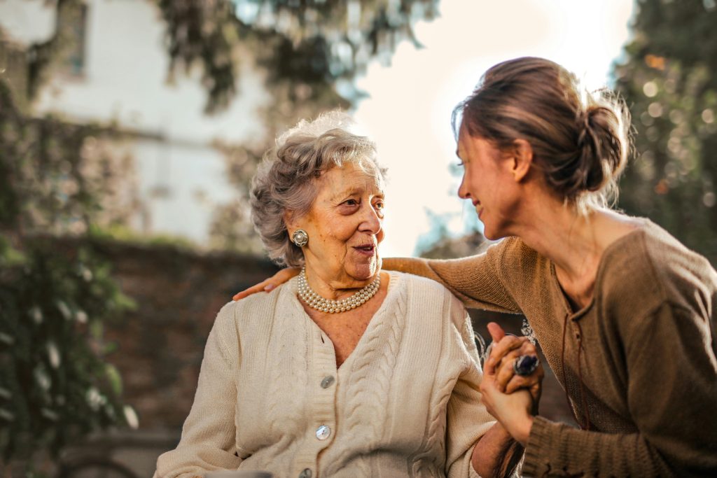 A younger woman talking with an older woman