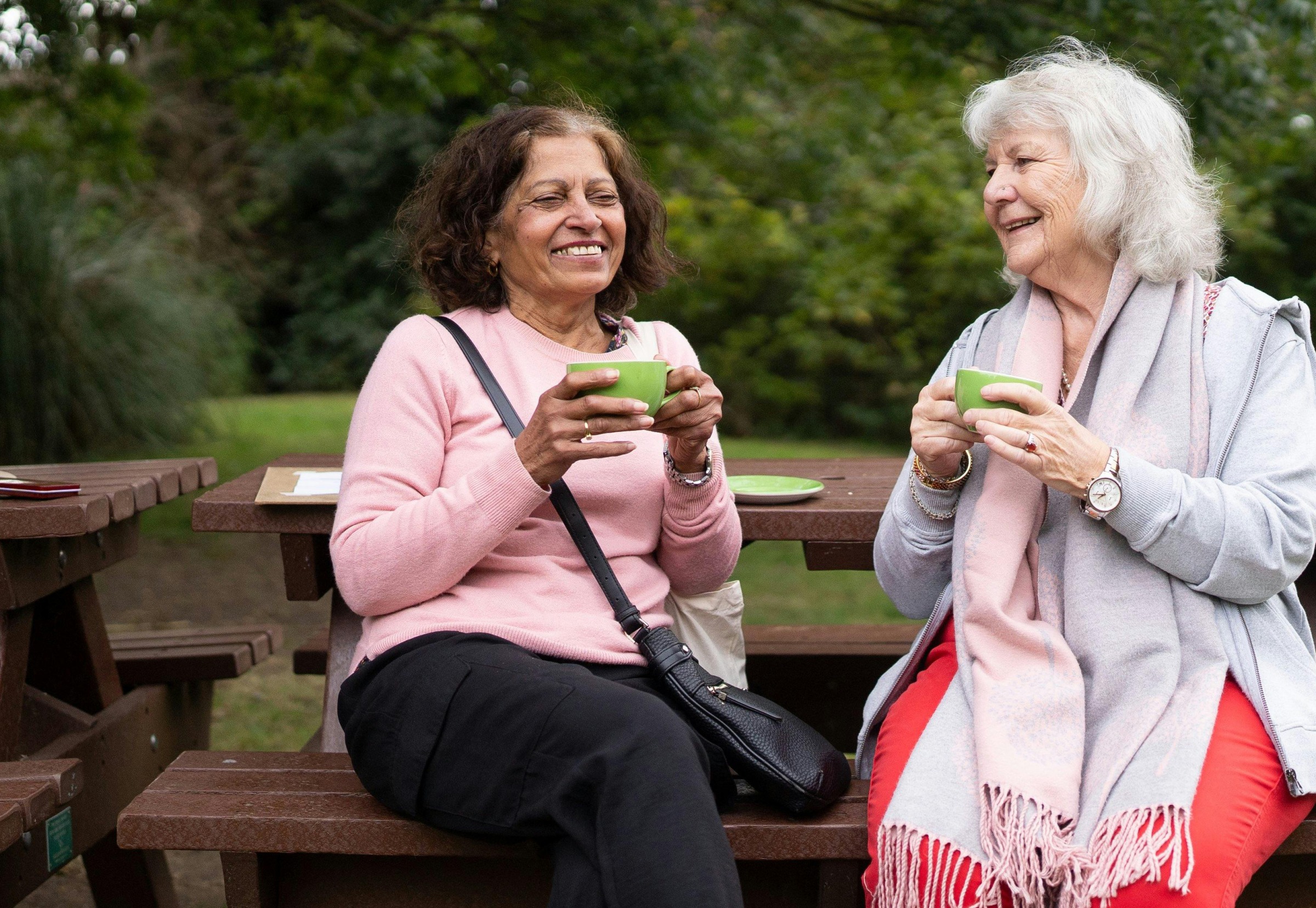 Two older women chatting in a park