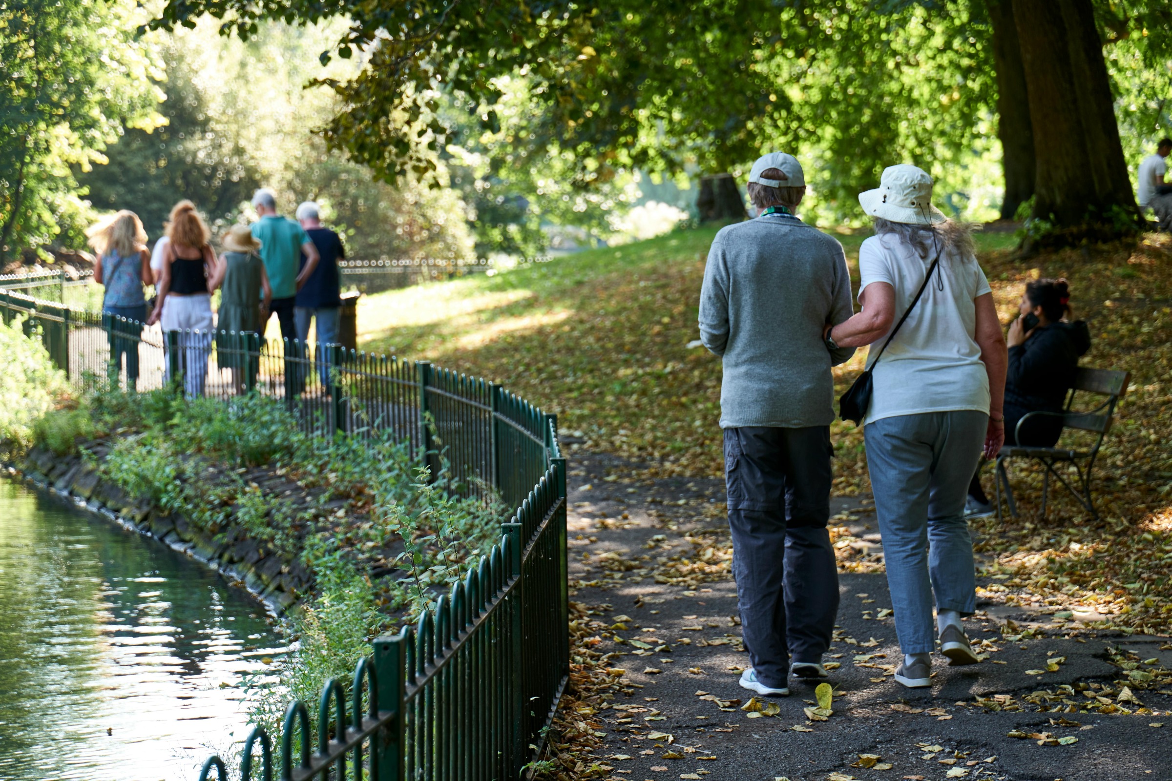 An older couple walking in a park