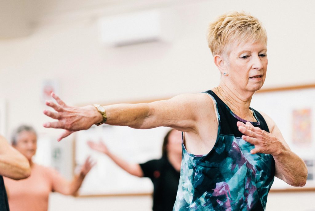 An older woman in an exercise class